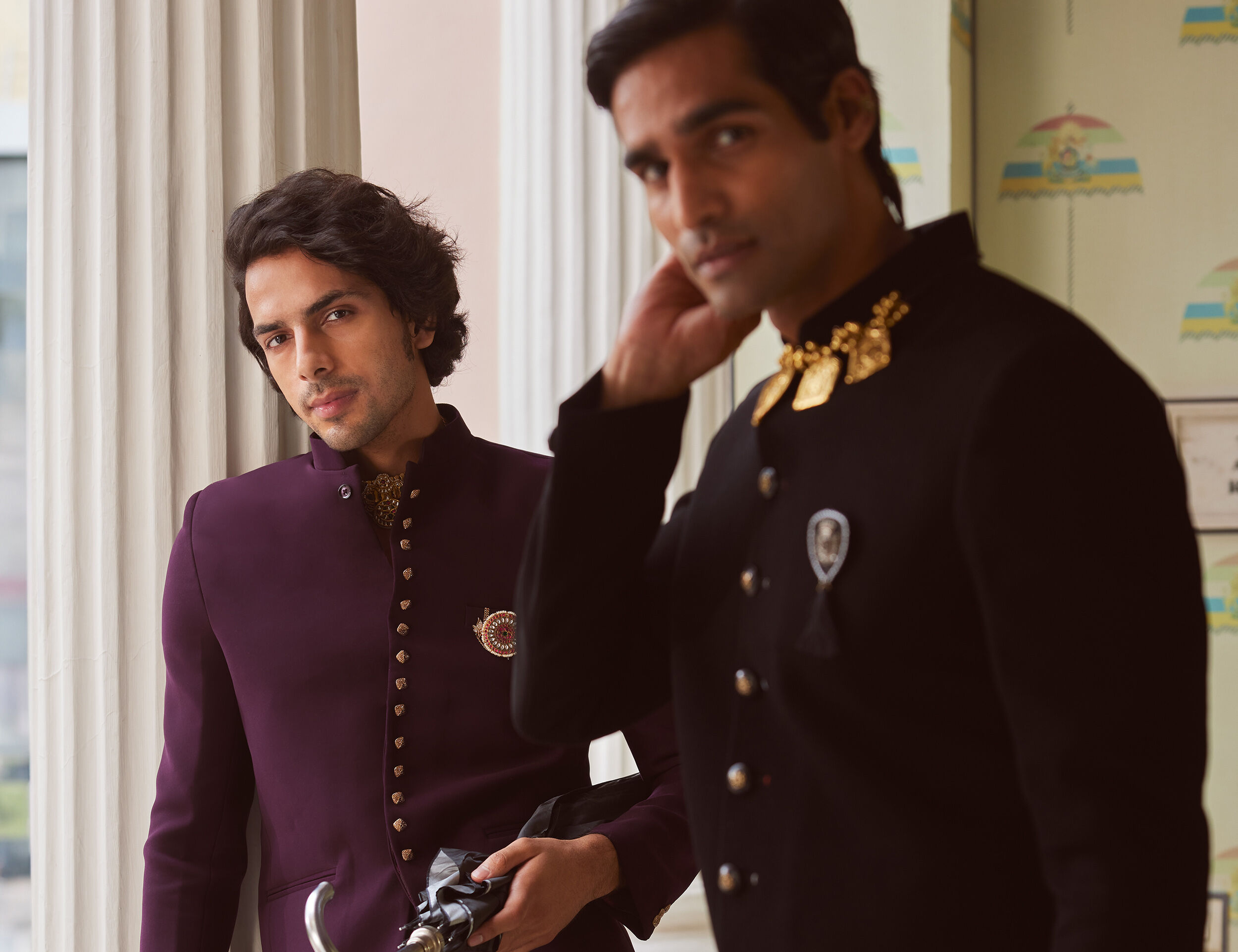 Man wearing Indo-Western sherwani adorned with gold brooches